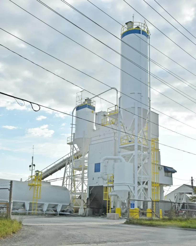 Ready Mix Concrete and Admixtures - ready-mix plant tower and silos beneath power lines